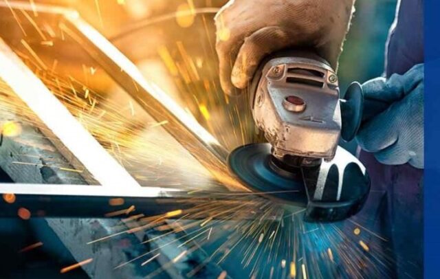 Worker using an angle grinder on metal
